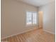 Bedroom featuring window with blinds, wood-look floors, and neutral walls at 100 E Fillmore St # 227, Phoenix, AZ 85004