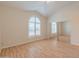 Bright, spacious bedroom with hardwood floors, vaulted ceiling, and large mirrored closet at 100 E Fillmore St # 227, Phoenix, AZ 85004