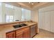Kitchen with stainless steel sink, tan counter tops and stainless steel appliances at 100 E Fillmore St # 227, Phoenix, AZ 85004