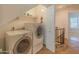 This functional laundry area features a modern washer and dryer with convenient shelving at 100 E Fillmore St # 227, Phoenix, AZ 85004