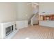 Open living room with fireplace, high ceilings, hardwood floors, open to kitchen, and stairway to the second floor at 100 E Fillmore St # 227, Phoenix, AZ 85004