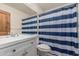 Bathroom featuring a striped shower curtain, modern vanity, and ample lighting at 1110 E Utopia Rd, Phoenix, AZ 85024