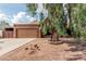 Charming home featuring a well-maintained front yard with mature tree and a two-car garage at 1110 E Utopia Rd, Phoenix, AZ 85024