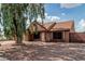 Charming home featuring a well-maintained front yard with mature tree, privacy fence, and a two-car garage at 1110 E Utopia Rd, Phoenix, AZ 85024
