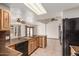 Open kitchen features wood cabinets, tile countertops, black appliances and tile floors at 1110 E Utopia Rd, Phoenix, AZ 85024