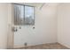 Bright laundry room with tile flooring and a window for natural light at 1110 E Utopia Rd, Phoenix, AZ 85024