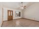 Bright living room featuring neutral tile flooring, vaulted ceiling, and a ceiling fan at 1110 E Utopia Rd, Phoenix, AZ 85024