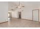 Open-concept living space with tile floors, ceiling fans, and a view into the kitchen at 1110 E Utopia Rd, Phoenix, AZ 85024