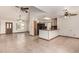 Expansive living space with tile flooring, ceiling fans, and a view into the kitchen at 1110 E Utopia Rd, Phoenix, AZ 85024