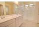 Bright Primary bathroom with double sinks, white cabinetry, glass shower, and tile floors at 1130 E Westwood Dr, Casa Grande, AZ 85122