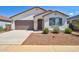 Charming single-story home with a well-maintained front yard, two car garage, and desert landscaping at 1130 E Westwood Dr, Casa Grande, AZ 85122