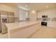 Modern kitchen features stainless steel appliances, a large center island, and sleek white cabinetry at 1130 E Westwood Dr, Casa Grande, AZ 85122