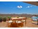 Outdoor patio featuring a dining table set and stainless steel grill, perfect for entertaining against a scenic mountain backdrop at 1130 E Westwood Dr, Casa Grande, AZ 85122
