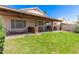View of the backyard features a spacious, covered patio and grassy area perfect for outdoor living and entertainment at 11411 W Dana Ln, Avondale, AZ 85392