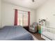 Bedroom with a crib and reading chair at 11411 W Dana Ln, Avondale, AZ 85392