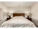 Bedroom featuring neutral walls and carpet, a wood headboard, and matching lamps at 11411 W Dana Ln, Avondale, AZ 85392
