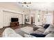 Living room showcasing a cozy sectional sofa, accent pillows and tile flooring at 11411 W Dana Ln, Avondale, AZ 85392