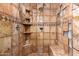 Beautifully tiled walk-in shower with shower head and built-in shelving at 11411 W Dana Ln, Avondale, AZ 85392