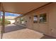 Covered back patio with brick flooring, access to yard and back door at 13414 E Cindy St, Chandler, AZ 85225