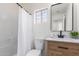 Bathroom featuring neutral tile, fresh paint, and a wood-look vanity with sink at 13414 E Cindy St, Chandler, AZ 85225