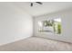 A bright bedroom with neutral carpet, fresh paint and large window to the backyard at 13414 E Cindy St, Chandler, AZ 85225