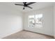 A bright bedroom with neutral carpet, fresh paint and large window to the front yard at 13414 E Cindy St, Chandler, AZ 85225