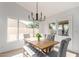Bright dining area featuring a wooden table, upholstered chairs, and a view of the backyard at 13414 E Cindy St, Chandler, AZ 85225