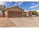 Single-story home featuring a wide two-car garage and desert-style landscaping in the front yard at 13414 E Cindy St, Chandler, AZ 85225