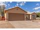 Single-story home featuring a wide two-car garage and desert-style landscaping in the front yard at 13414 E Cindy St, Chandler, AZ 85225