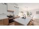 A modern kitchen featuring an island, stainless steel appliances and seating for three at 13414 E Cindy St, Chandler, AZ 85225