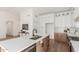 A modern kitchen featuring an island, stainless steel appliances, hardwood floors and bright white walls at 13414 E Cindy St, Chandler, AZ 85225