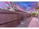 Fenced backyard with rock groundcover and access to brick-lined walkway at 146 E 1St St, Mesa, AZ 85201