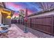Private backyard featuring a brick walkway, gravel landscaping, and secure wood fencing at 146 E 1St St, Mesa, AZ 85201