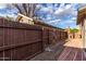 Private fenced backyard with low-maintenance gravel and brick pathway at 146 E 1St St, Mesa, AZ 85201