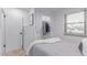 Cozy bedroom featuring a comfortable bed, closet space with drapes, and ample natural light from the window at 146 E 1St St, Mesa, AZ 85201