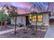 Single-story home featuring charming front yard landscaping and decorative potted plants at 146 E 1St St, Mesa, AZ 85201