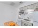 Functional kitchen with stove, sink, and microwave provides the essentials for meal prep, perfect for simple living at 146 E 1St St, Mesa, AZ 85201