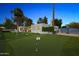 Expansive backyard featuring a lush putting green, mature landscaping, and patio area ideal for outdoor entertaining at 14802 N 3Rd Ave, Phoenix, AZ 85023