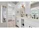 Updated bathroom with dual sinks, quartz counters, modern mirrors, and access to a walk-in closet at 14802 N 3Rd Ave, Phoenix, AZ 85023