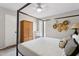 Bedroom featuring a four-poster bed with a woven side closet and window at 14802 N 3Rd Ave, Phoenix, AZ 85023