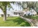 Attractive white home with mature trees, lush lawn, and a charming blue gated entrance at 14802 N 3Rd Ave, Phoenix, AZ 85023