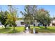 Attractive white home with mature trees, lush lawn, and a charming blue gated entrance at 14802 N 3Rd Ave, Phoenix, AZ 85023