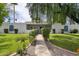 Charming single-story home with lush landscaping, gated entrance, and freshly cut green lawn at 14802 N 3Rd Ave, Phoenix, AZ 85023