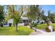 Inviting single-story home with well-maintained lawn and landscaping, including mature trees at 14802 N 3Rd Ave, Phoenix, AZ 85023