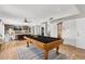 Elegant game room featuring a wooden pool table and a view of the adjacent living area at 14802 N 3Rd Ave, Phoenix, AZ 85023