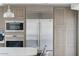 Modern kitchen with stainless steel appliances, microwave and refrigerator with matching wood cabinetry at 14802 N 3Rd Ave, Phoenix, AZ 85023