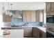 Well-equipped kitchen with stainless appliances, stylish blue backsplash, and white countertops at 14802 N 3Rd Ave, Phoenix, AZ 85023