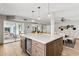Bright, open kitchen featuring a large island with a beverage fridge and modern pendant lighting at 14802 N 3Rd Ave, Phoenix, AZ 85023