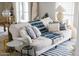 Bright living room featuring a stylish sofa, patterned cushions, and natural light at 14802 N 3Rd Ave, Phoenix, AZ 85023