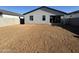 Spacious backyard awaiting landscaping, featuring a patio and potential for outdoor entertaining at 15792 W Beryl Ave, Waddell, AZ 85355